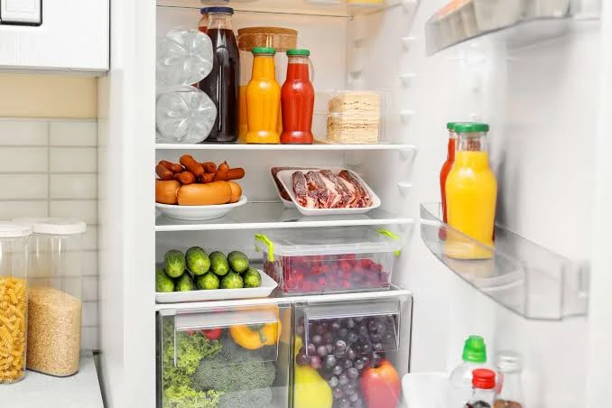 Open fridge stocked with fresh ingredients