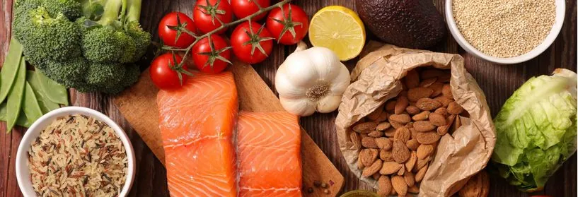 Whole foods including salmon, broccoli, tomatoes, garlic, almonds, rice and lettuce