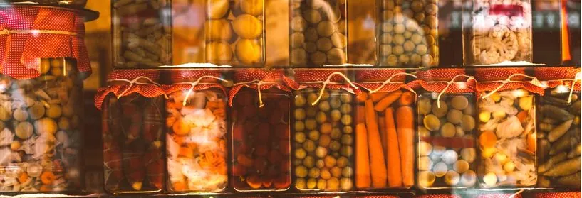 Shelves of jars filled with pickled vegetables